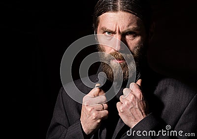 Old Believer Senior Prayer, bearded old man praying on a dark background Stock Photo