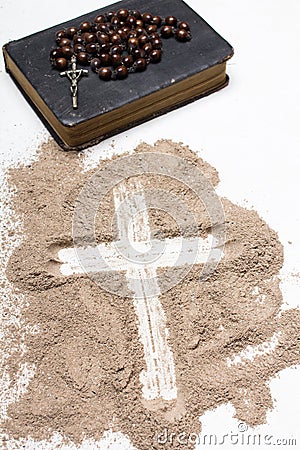 Old Bible, rosary and Cross of ash on white background - Ash Wednesday Stock Photo