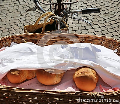 old bicycle of baker with basket with three pieces of fragrant b Stock Photo