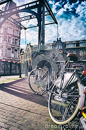 Old bicycle on bridge. Amsterdam cityscape Stock Photo