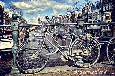 Old bicycle on bridge. Amsterdam cityscape Stock Photo