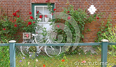 An old bicycle in front of a farmhouse Stock Photo