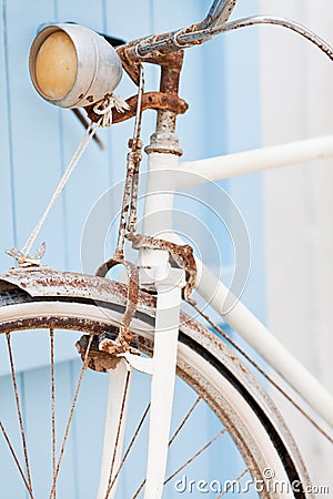 Old bicycle leaning against blue door. Stock Photo