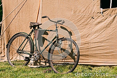 Old Bicycle Parked Next To Large Soviet Military Canvas Khaki Tent Stock Photo