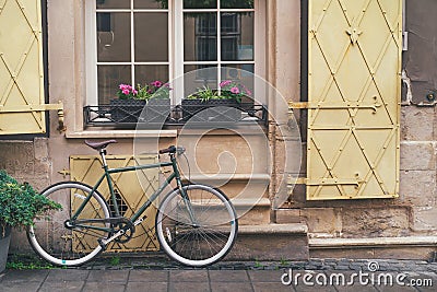 Old bicycle stands under the windows of the hotel in downtown Lviv Stock Photo