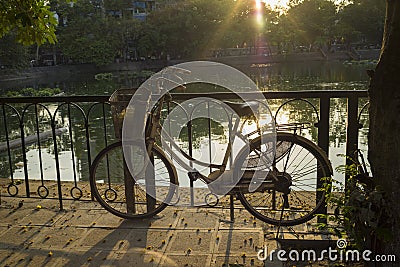 Old bike on urban pavement under afternoon bright sunlight Stock Photo