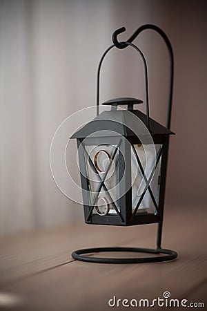 Old black candle lamp on the table Stock Photo