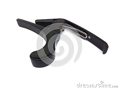 Old black color guitar capo isolated on white background Stock Photo