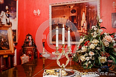 Old black grand piano with burning candles in candlestick at lid Editorial Stock Photo