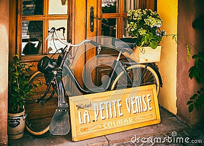 Old black moped in a shop window in historic Colmar in the Little Venice district Editorial Stock Photo