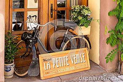 Old black moped in a shop window in historic Colmar in the Little Venice district Editorial Stock Photo