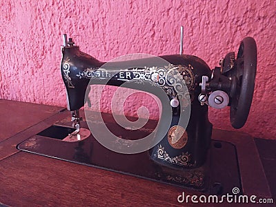 Old black sewing machine in the foreground Editorial Stock Photo