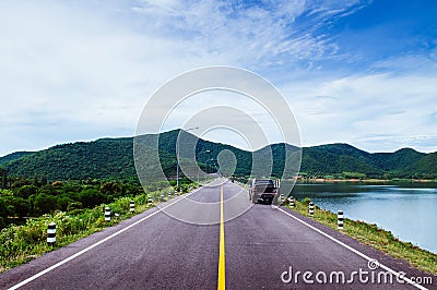 Old black Truck park by lake with summer sky and mountain Stock Photo