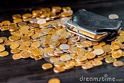 An old black wallet sits on top of a pile of Russian coins. The concept of inflation and poverty Stock Photo