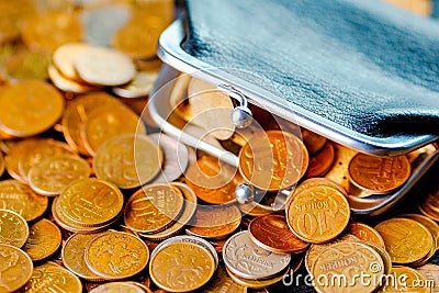 An old black wallet sits on top of a pile of Russian coins. The concept of inflation and poverty Stock Photo