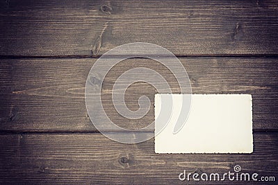 The old blank photo lying on a wooden desk Stock Photo