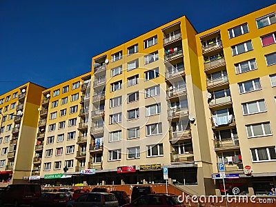 Old block of flats with reconstructed facade of yellow color going down with gradient into beige Editorial Stock Photo