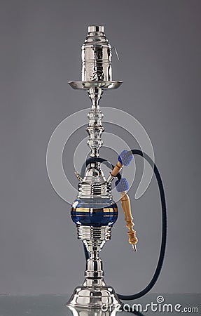 An old blue ceramic hookah on a grey background Stock Photo