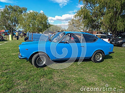 Old blue 1972 Fiat 125 Sport coupe fastback Berlinetta on lawn Editorial Stock Photo