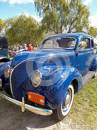Old blue 1938 Ford V8 85 De Luxe coupe in a park. Classic car show. Editorial Stock Photo