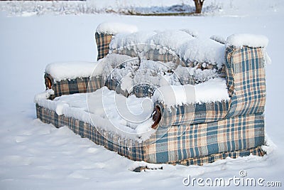 Old Furniture Left Outside in the Snow Stock Photo