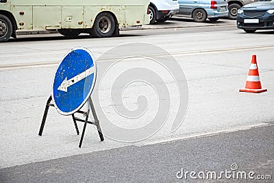 Old blue road sign detour to the left Stock Photo