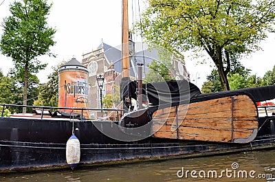 Old boat in a canal in Amsterdam Editorial Stock Photo