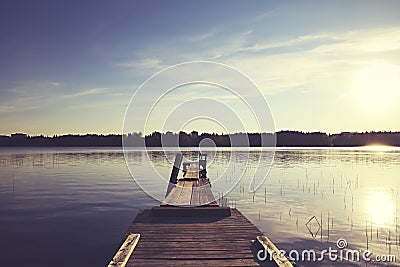 Boat pier on a lake with great sunlight Stock Photo