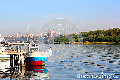 The old boat by a pier Stock Photo