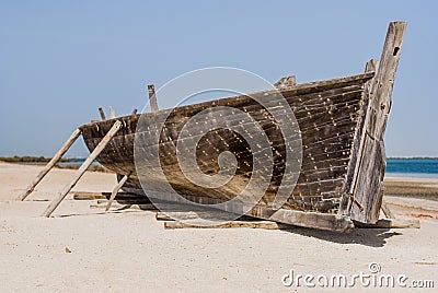 Old boat from wood standing on sand Stock Photo