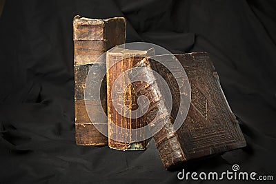 Old book spines on black background. Ancient library. Antique Ho Stock Photo