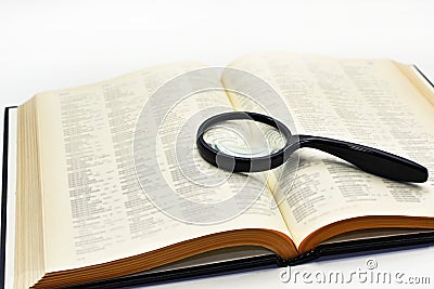 Old books with magnifying glass. Stock Photo