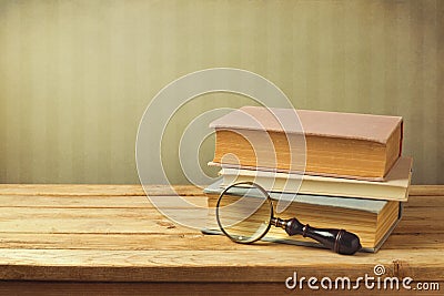 Old books with vintage magnifying glass Stock Photo