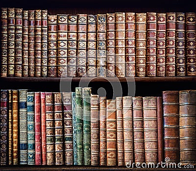 Old books on vintage wooden shelf. Stock Photo