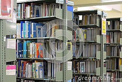 Old bookshelf with books arranged neatly in a wide variety of large libraries.. Editorial Stock Photo