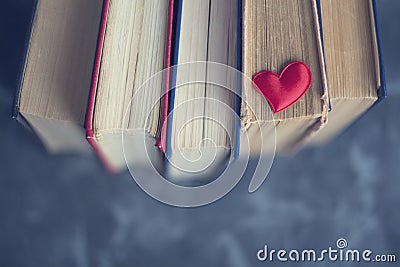 Old bookstore the blue background with little red heart top view. Love reading books Stock Photo