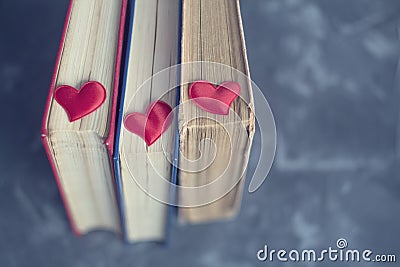 Old bookstore the blue background with little red hearts top view. Love reading books Stock Photo