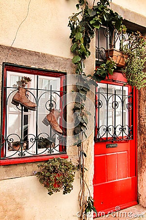 Old boots hanging on a window in Lisbon Stock Photo