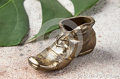 Old brass ashtray in the shape of a shoe Stock Photo