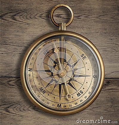 Old brass compass on wood table Stock Photo