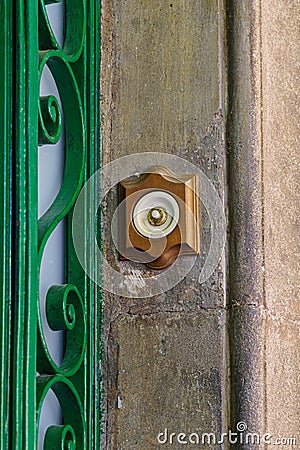 Old brass doorbell on a house door Stock Photo