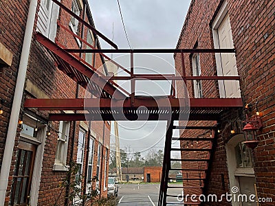 Old brick building facade holiday lights vintage under stair case view Editorial Stock Photo