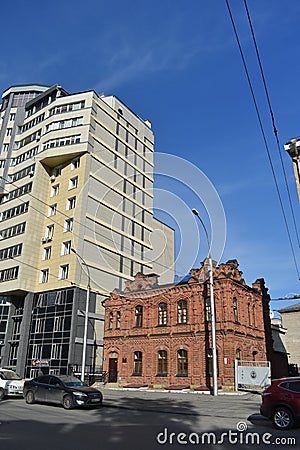 The old brick house near big modern houses Editorial Stock Photo