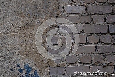 An old brick wall made of white brick, with crumbling plaster. Stock Photo