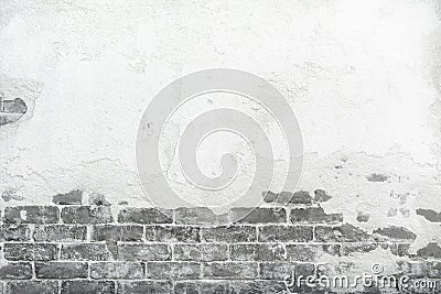 Old brick wall with peeling cracking cement plaster, grunge background Stock Photo