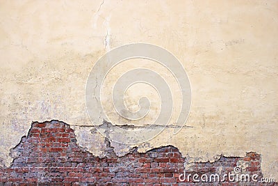 Old brick wall with peeling plaster, grunge background Stock Photo