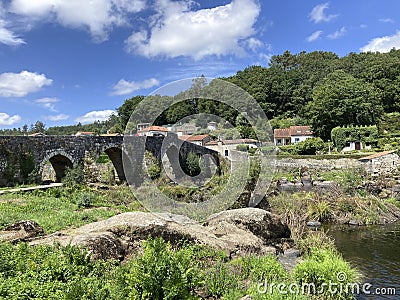 The Old Bridge, a medieval bridge over the river Tambre along the Camino de Santiago. Galicia, Spain. Editorial Stock Photo