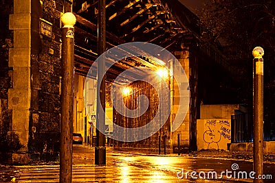 Old bridge on Place de l`Argonne in Paris on a rainy night Stock Photo