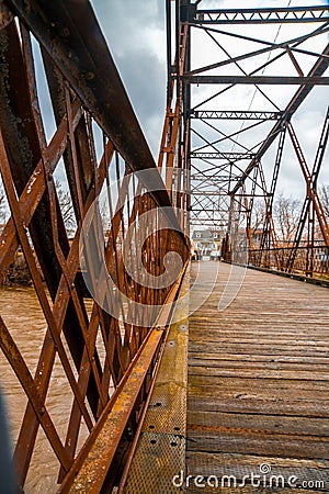 Old bridge in rusty metal structure and wooden floor of Saint-Pie, Quebec Stock Photo