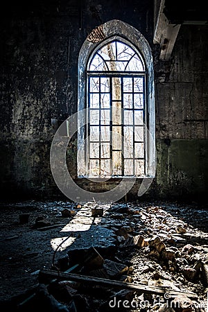 Old broken lancet window inside abandoned building Stock Photo